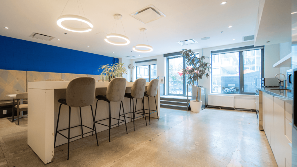 Lounge in a coworking space with high-top chairs and table